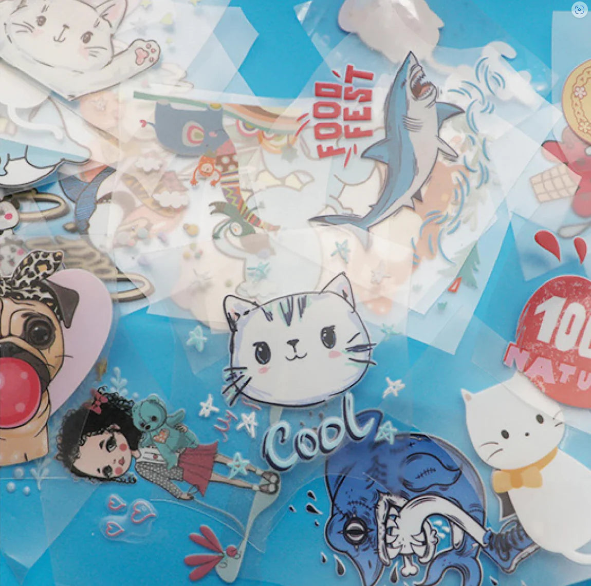 Custom UV DTF sticker gang sheet with various colorful designs including cats, shark, pug, girl character, and food fest logo on a blue background