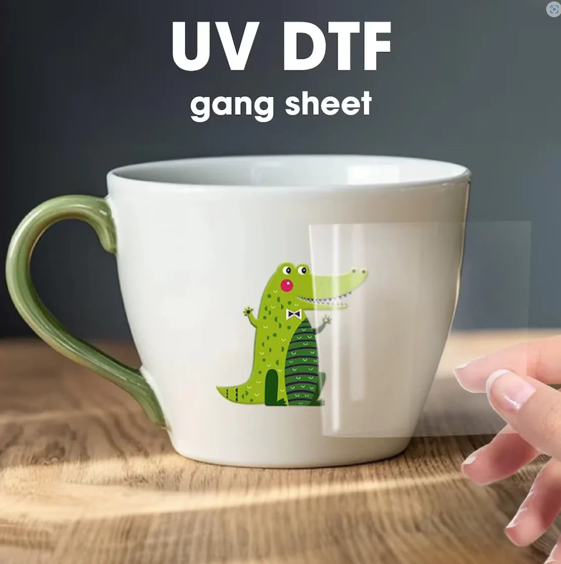 Custom UV DTF stickers applied on a ceramic mug, showing a colorful crocodile design with a clear gang sheet being peeled off for decoration