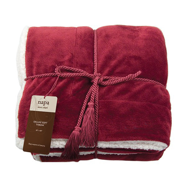 Red deluxe lambswool throw blanket with white fleece lining, tied with matching cord and branded tag