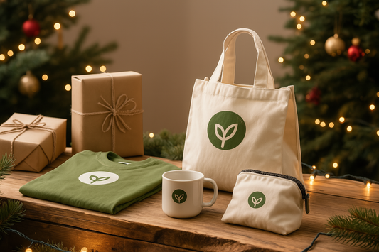 Eco-friendly holiday gift display with a cotton tote bag, green organic T-shirt, ceramic mug, and zippered canvas pouch, set against a festive background with Christmas trees, string lights, and kraft-wrapped gifts