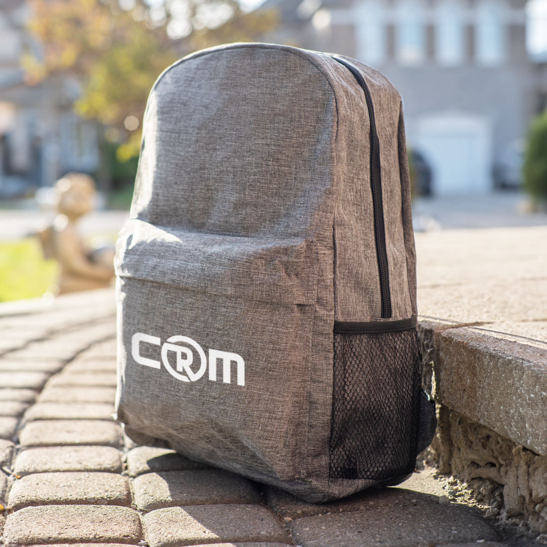 Gray backpack with logo on a stone surface outdoors