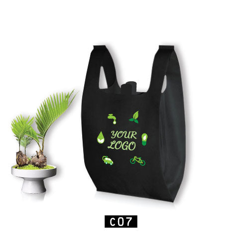 A black T-Shirt shopping bag with eco-friendly design next to a potted plant, repeating 'eco-friendly' text pattern in white.