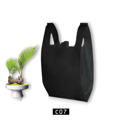 A black T-Shirt shopping bag with eco-friendly design next to a potted plant, repeating 'eco-friendly' text pattern in white.