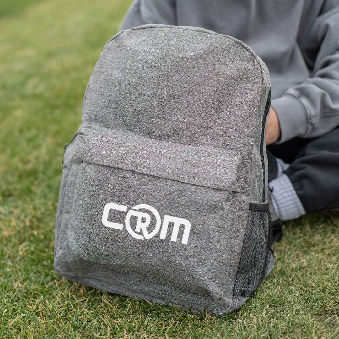 Tecumseh heather backpack 12"W x 7"D x 18"H in green with front zipper pocket, mesh side pocket, and custom CRM logo print