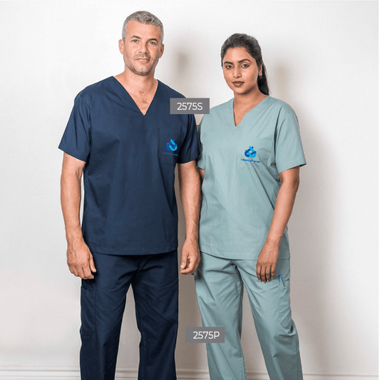 Male and female models wearing navy and green cargo scrub sets with custom embroidered logo