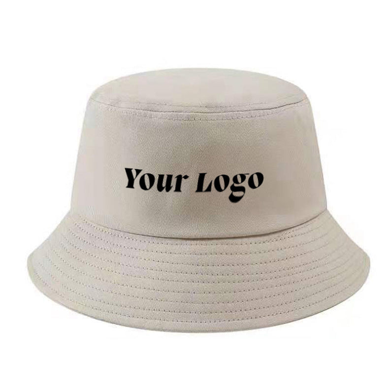 Beige custom bucket hat with "Your Logo" printed in black on the front.