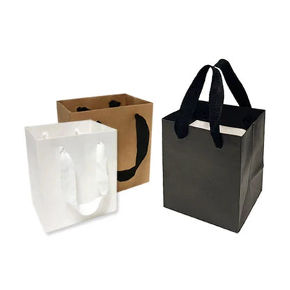 Extra small Manhattan style heavy weight paper bags 200gsm in black, white, and kraft with custom logo print and sturdy handles, 5 inches wide, 4 inches deep, 6 inches high