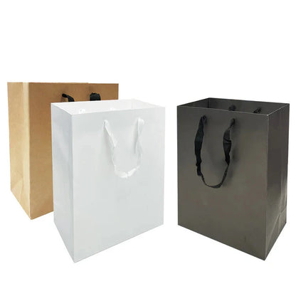 Manhattan style heavyweight paper bags, 200gsm, medium size 10 inches wide by 5 inches deep by 13 inches high, shown in kraft, white, and black with custom logo and rope handles.