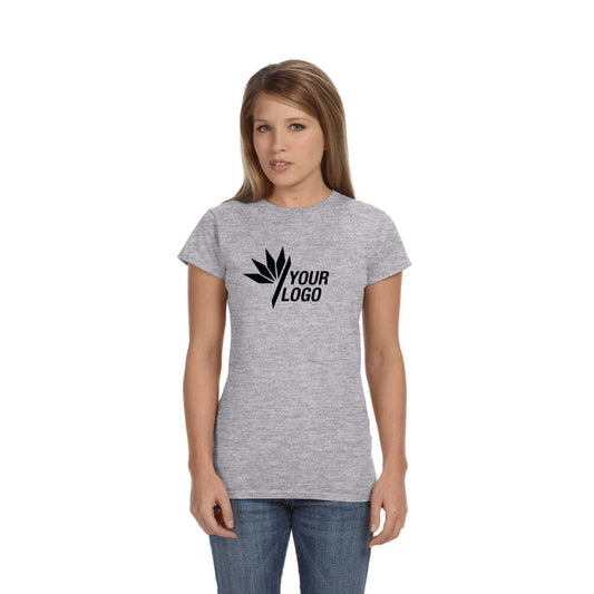 Gildan Softstyle® T-Shirt G640L for ladies in grey, featuring a custom black logo on the chest, worn by a woman with long hair and blue jeans.