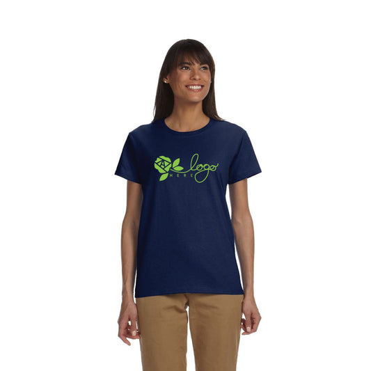 Gildan Ultra Cotton® T-shirt G200L for ladies in navy blue, featuring a green floral logo design on the chest, worn by a woman with long dark hair and beige pants.